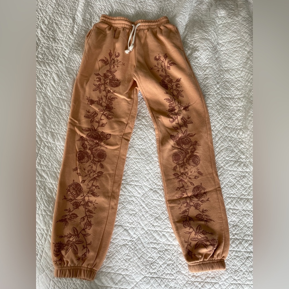 Urban outfitters orange sweatpants with flower detailing!